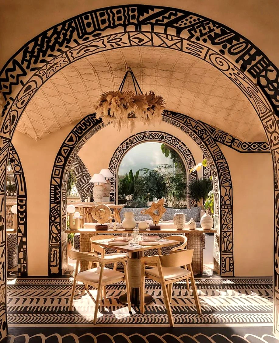 Ornamental arch framing a restaurant dining room with patterned chairs