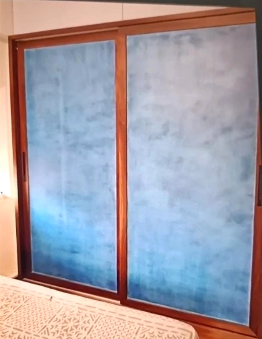 Blue-grey textured wall panels framed in warm timber