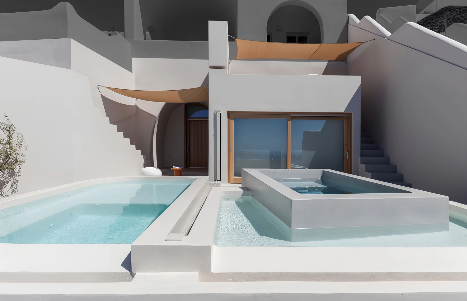 Pale mineral-finish terraces and pools beside a residence with curved walls and shade sails