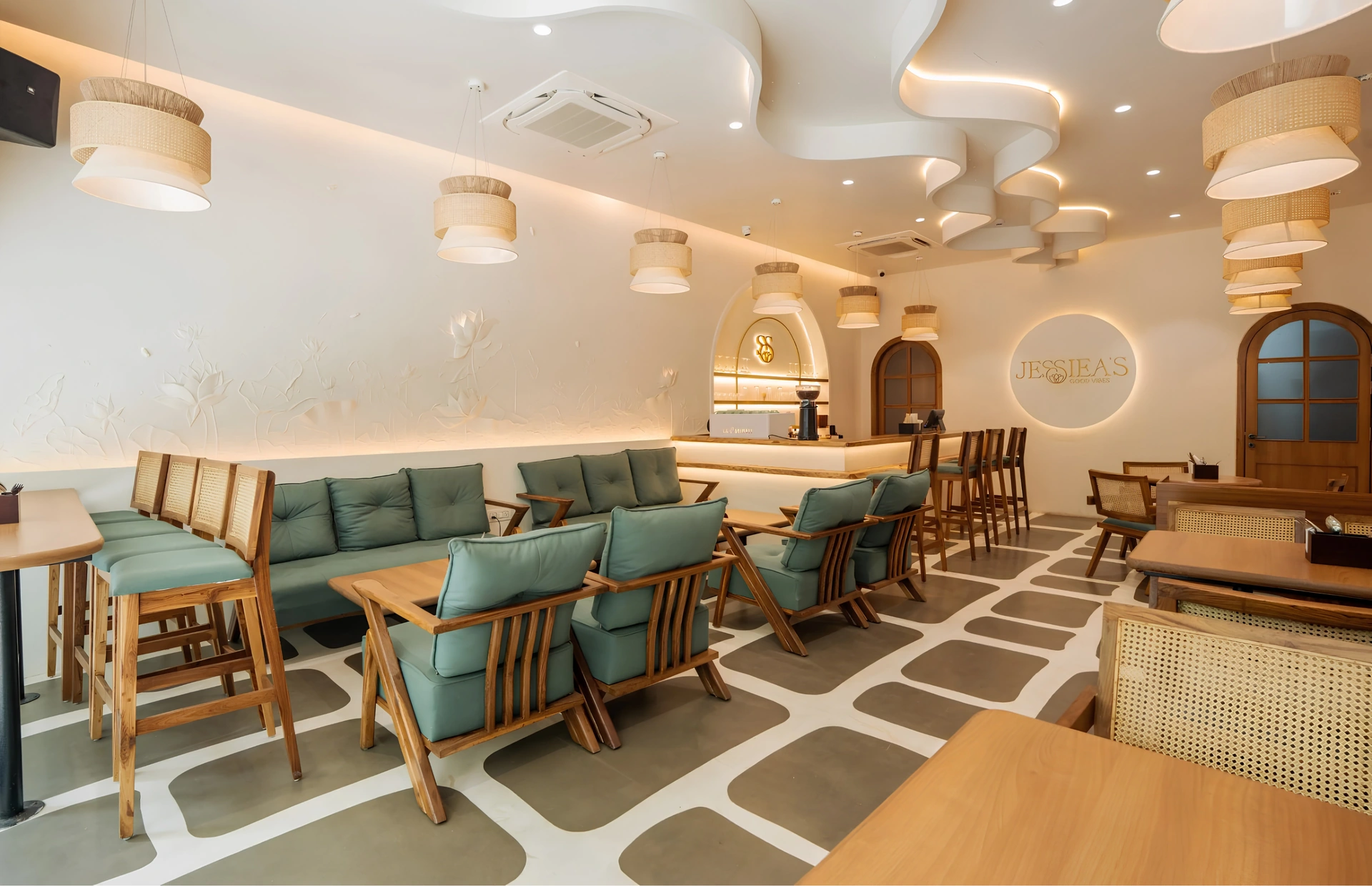 Restaurant with sculptural cream ceilings, teal seating and patterned flooring